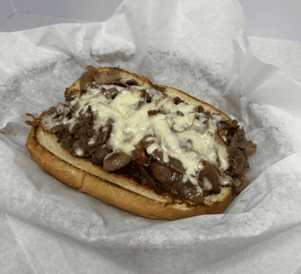 A sandwich filled with beef, onions, peppers, and melted cheese on a toasted hoagie roll.