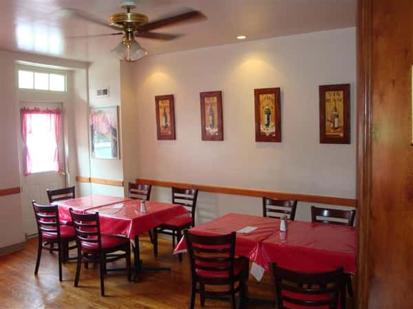 interior dining area with tables and chairs with paintings on the wall