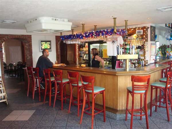 interior bar area with stools and decorative lighting