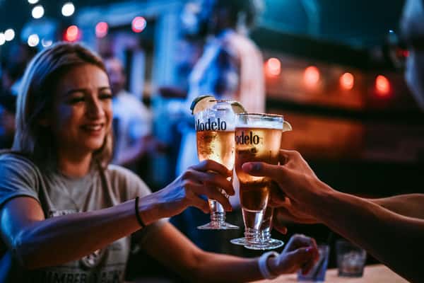 People clinking glasses at a bar