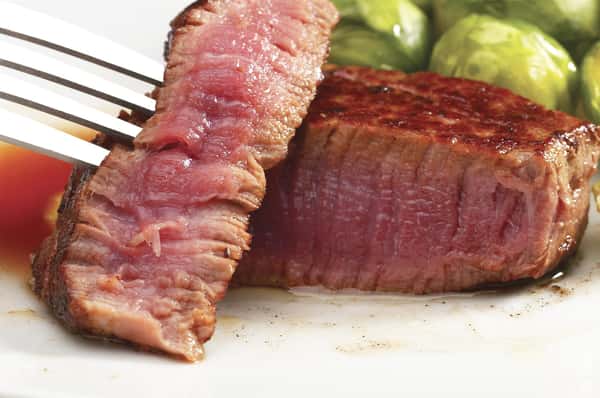 Prime rib steak with a fork in it