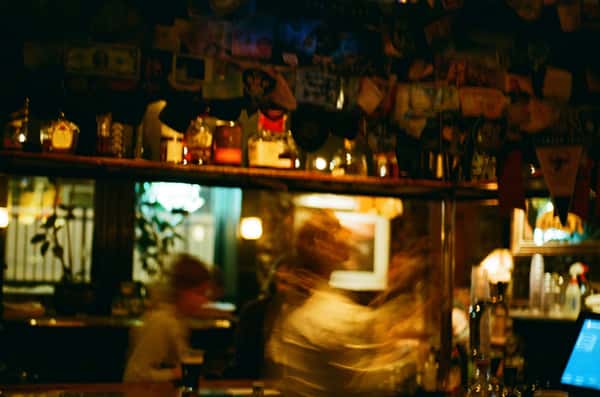 Long exposure shot of people moving around a bar
