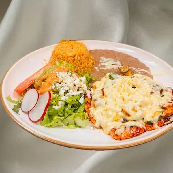 Chicken breast covered in melted white cheese, served with rice, refried beans, and a side salad.
