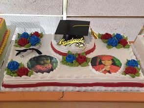 graduation cake with printed photos on top and cap