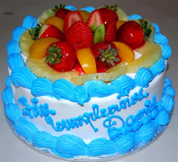 cake with icing topped with sliced fruit