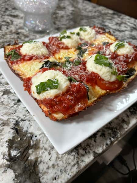 Fresh mozzarella blend, basil, vine-ripened peeled tomato sauce, oregano and parmesan cheese.
