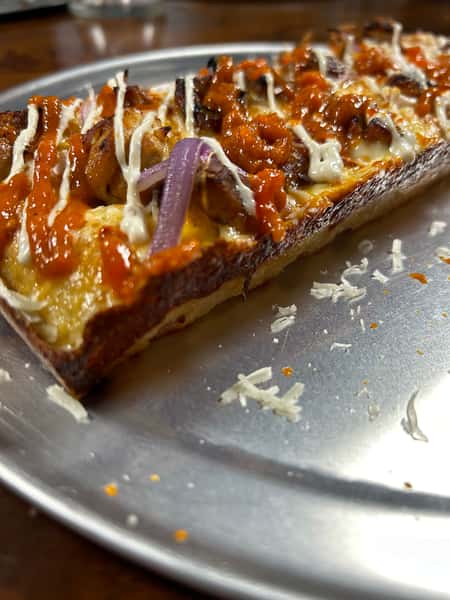 Pizza with Mozzarella blend, spicy buffalo sauce, grilled chicken, blue cheese crumbles, and ranch drizzle.