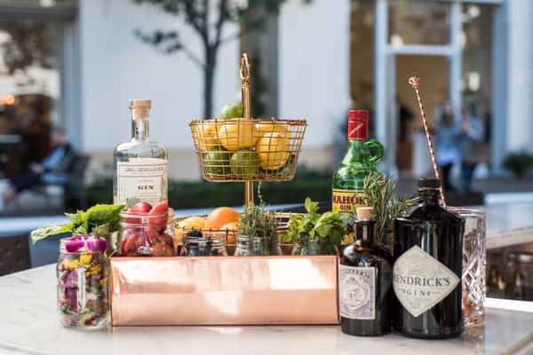 display of fresh fruits and herbs, with cocktails and spirits