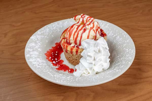 Butter cream cake topped with ice cream