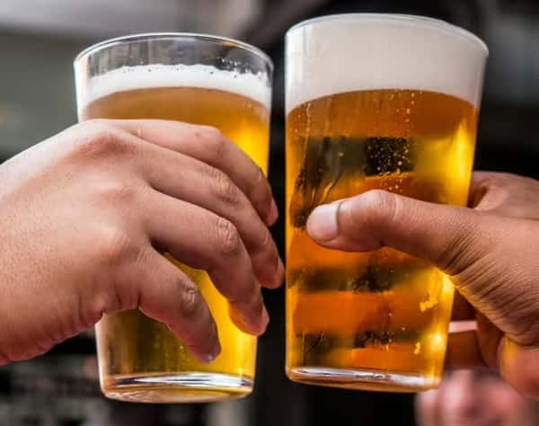 two drinks being raised to cheers