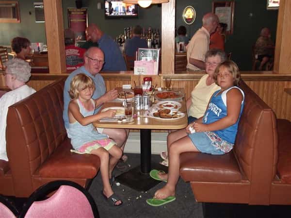 Family sitting at a dining booth in the restaurant