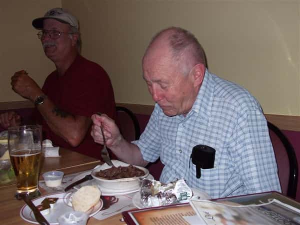 Two men eating at a table