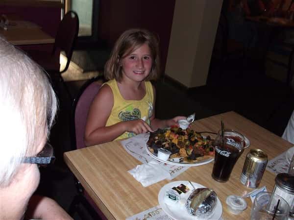 Little girl gettign ready to eat and smiling for photo
