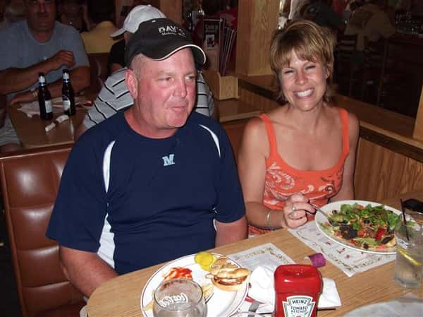 Couple eating at the table and posing for photo