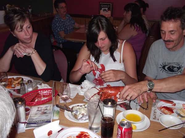 People eating lobster at the table
