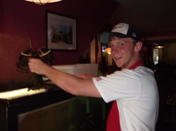 Member of staff holding a lobster