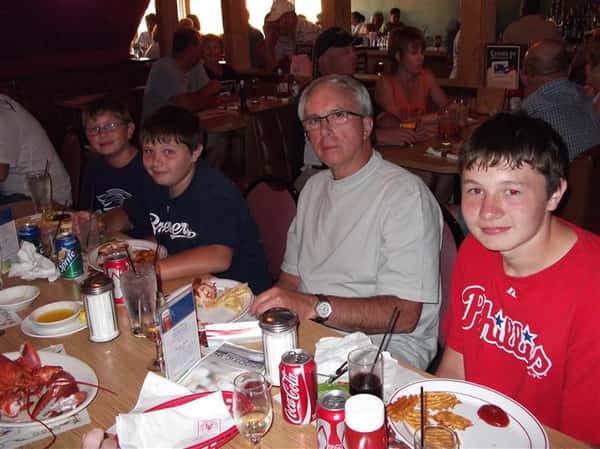 People eating at the table and posing for photo