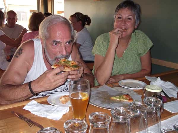 People having pizza and beer at the table
