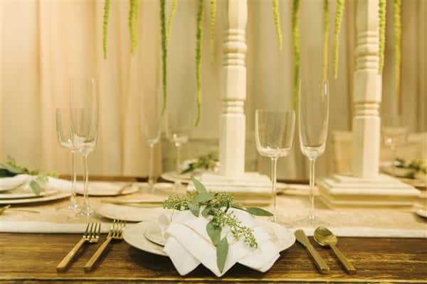 closeup of place setting with leaves on top of napkin