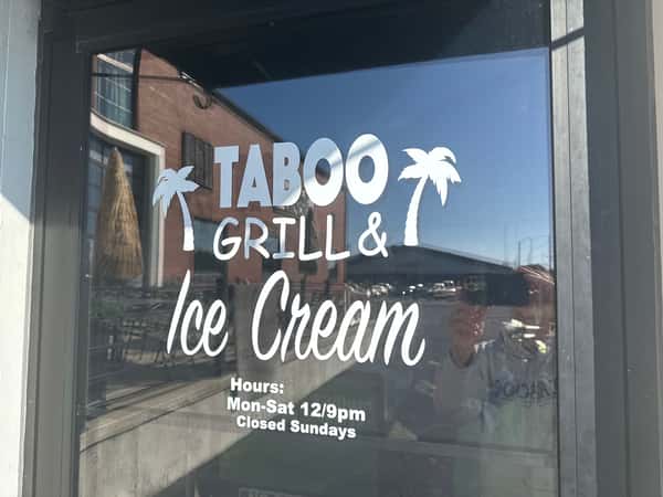 Exterior signage on glass door at restaurant