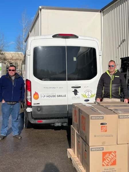Josh and Dan behind van with Food bank meals