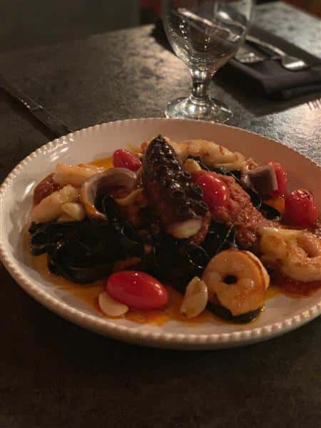 Seafood Salad including octopus, shrimp, garlic cloves and tomatoes