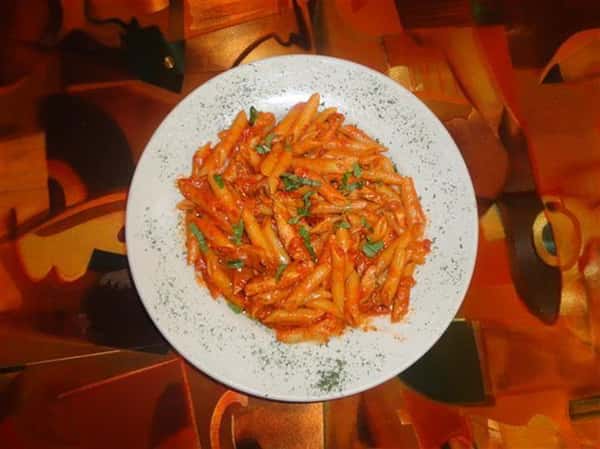 penne ala vodka in a bowl with herbs