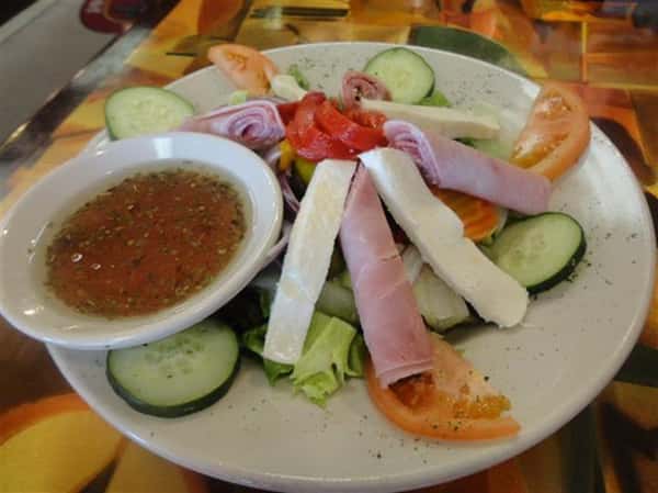 salad with ham, mozzarella cheese, cucumber and tomatoes