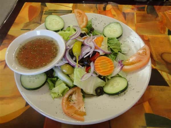 salad with cucumber, tomatoes, carrots, onions and peppers