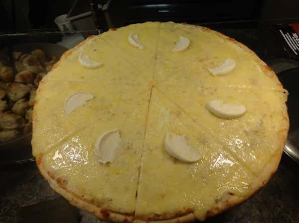 large cheese pizza with mozzarella slices on top