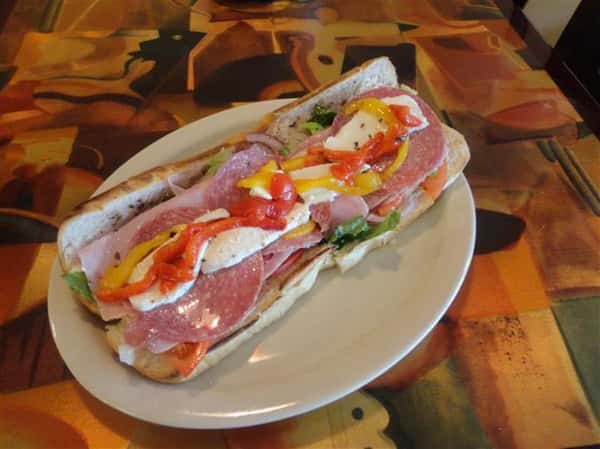 italian hero with meats, lettuce, tomatoes, peppers and mozzarella cheese
