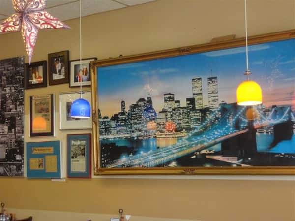 various pictures of new york framed on the inside walls