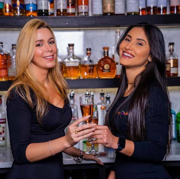 Women holding drinks