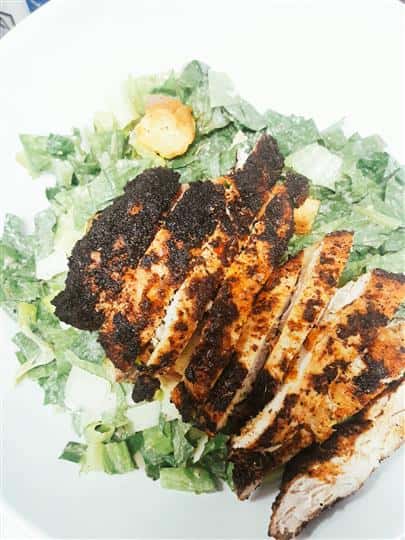 grilled chicken strips on a bed of lettuce
