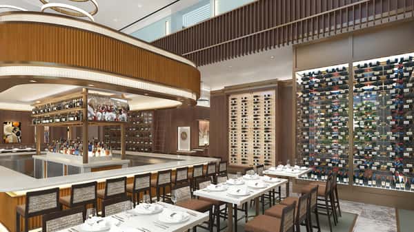 Upscale oyster bar and dining area featuring illuminated wine walls, contemporary design, and refined restaurant seating.