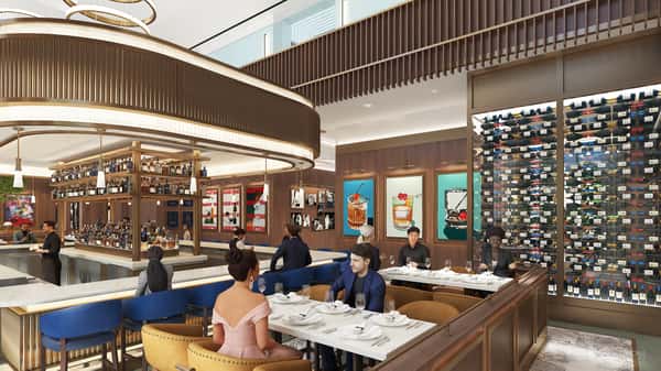 Elegant private dining room with floor-to-ceiling wine displays, modern chandeliers, and refined seating for special events and group gatherings.