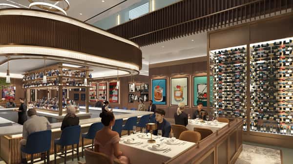 Sophisticated restaurant bar and dining area featuring illuminated shelving, premium seating, and a lively upscale atmosphere.