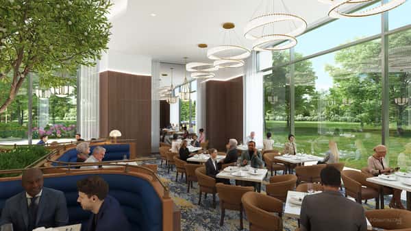 Elegant fine dining area with floor-to-ceiling windows, designer chandeliers, and refined seating overlooking lush outdoor views.