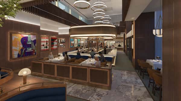 Upscale restaurant dining room with open kitchen views, modern lighting fixtures, and sophisticated contemporary décor.