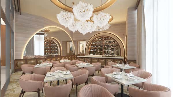 Elegant Champagne Room with plush seating, arched wine displays, statement floral chandelier, and sophisticated fine dining ambiance.