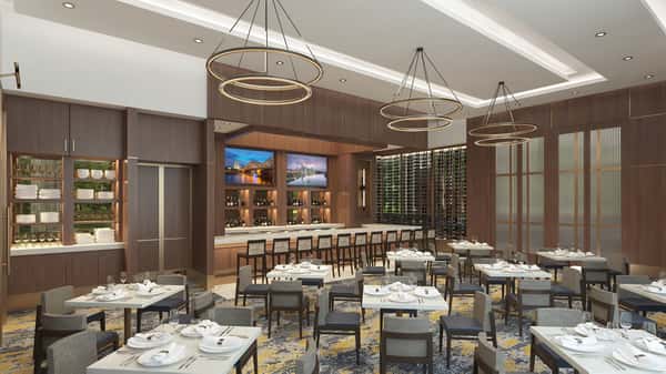 Elegant private dining room with floor-to-ceiling wine displays, modern chandeliers, and refined seating for special events and group gatherings.