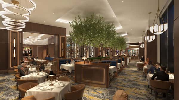 Elegant fine dining restaurant interior with warm lighting, upscale seating, lush greenery, and sophisticated contemporary décor.