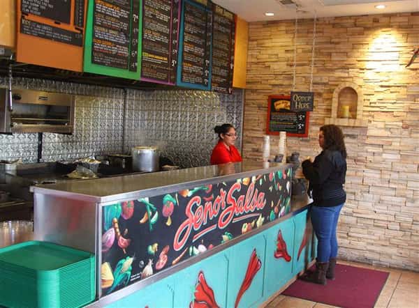 Restaurant counter with menu boards overhead