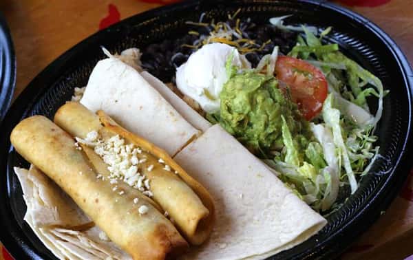 Taquitos served with tortillas and salad on the side