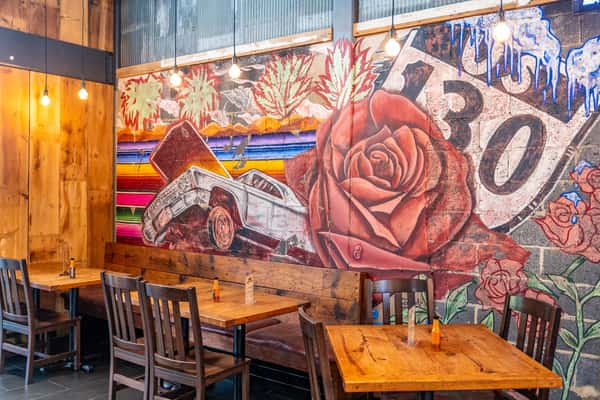 tabes in front of wall mural