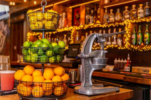 baskets of citrus next to juicer
