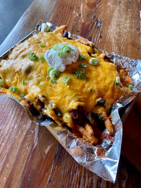 fries topped with brisket chili, cheddar cheese, sour cream, green onion