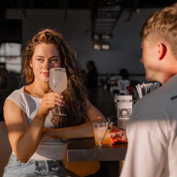Couple enjoying cocktails together at the bar