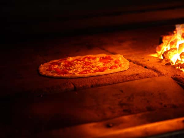 pizza inside brick oven