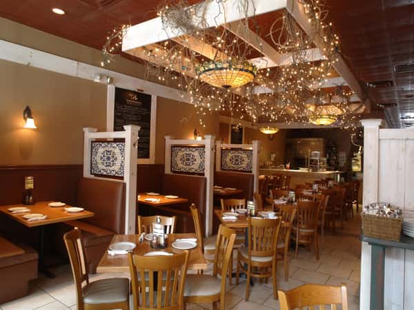interior of restaurant with tables and booths set for service